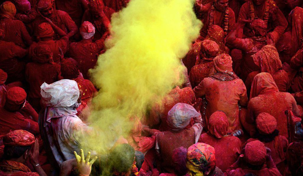 men covered in red powder