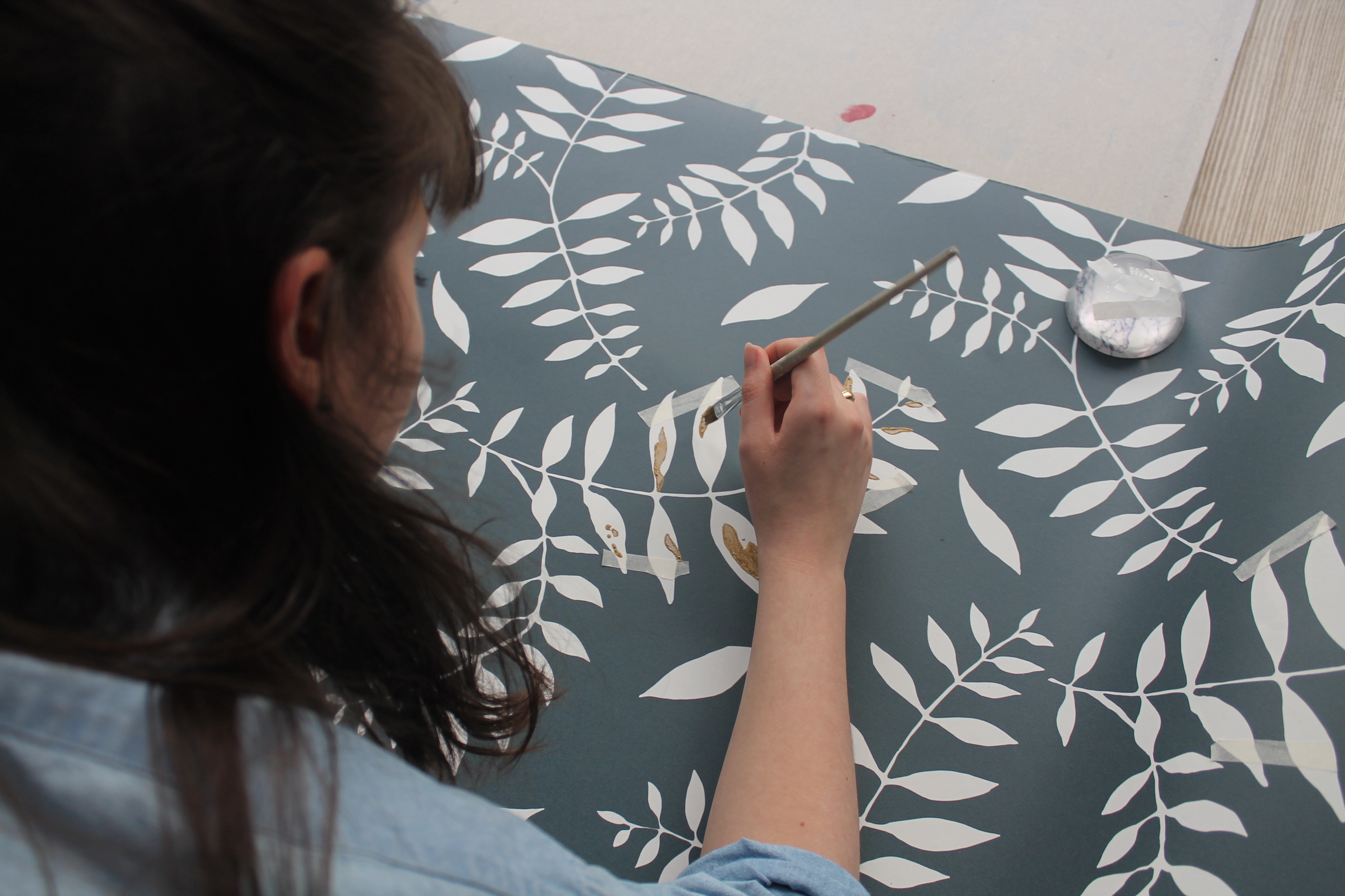 Melissa draws on wallpaper